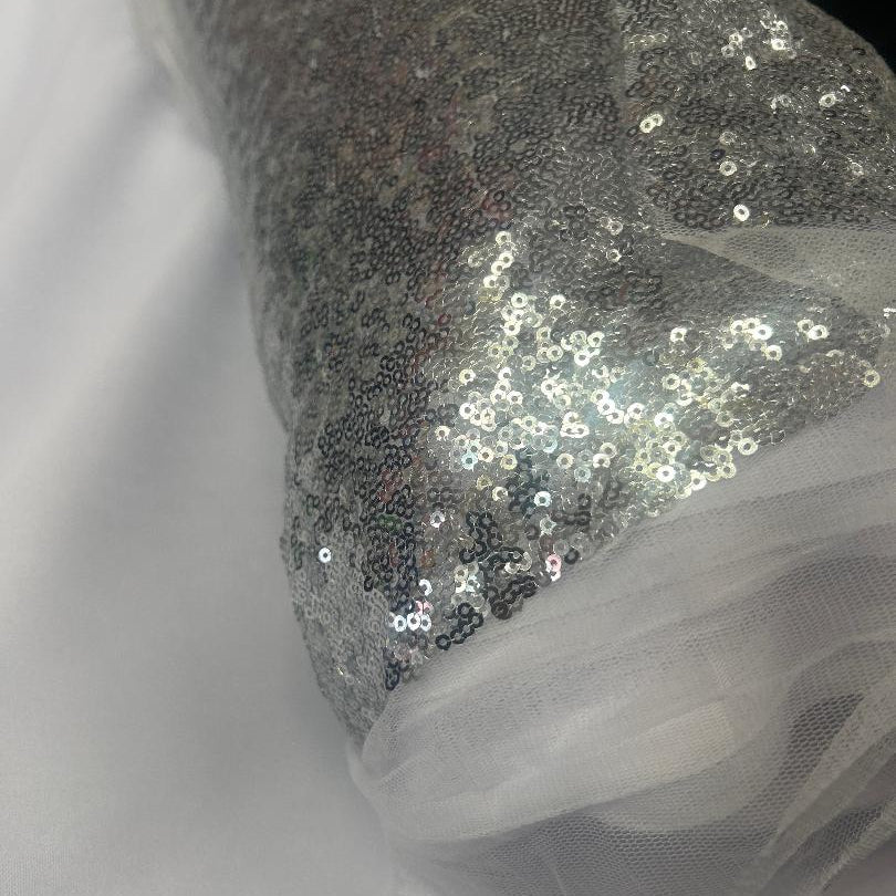 Silver sequin fabric roll 50 yards continuous piece on white background for wedding backdrop and event decor